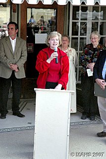 U.S. Representative Tammy Baldwin making a congratulatory speech. WI State Sen. Jon Erpenbach, our founder Marlene Schmalbeck, and building donor Ruth Knight-Sybers are in the background.